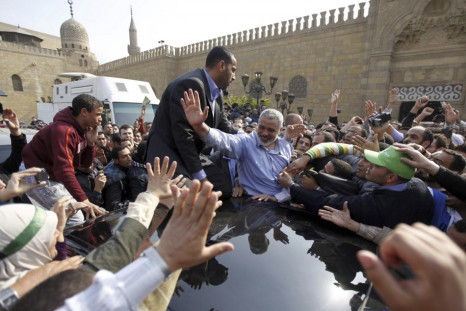 Hamas leader Ismail Haniyeh waves to his supporters following his speech after Friday prayers at Al-Azhar mosque in Cairo