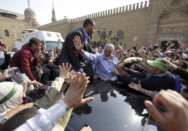 Hamas leader Ismail Haniyeh waves to his supporters following his speech after Friday prayers at Al-Azhar mosque in Cairo