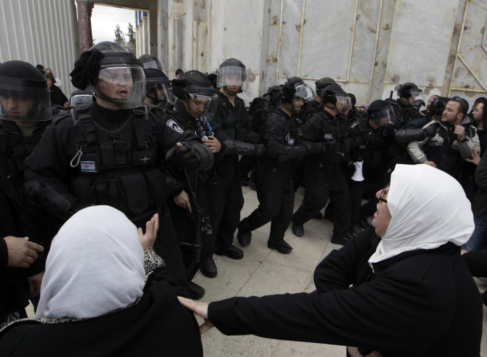 Palestinian women shout at Israeli policemen