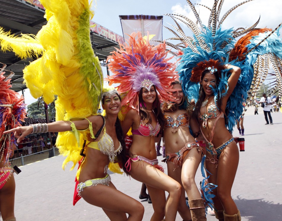 Masqueraders dance on stage on the final day of the carnival at Queens Park