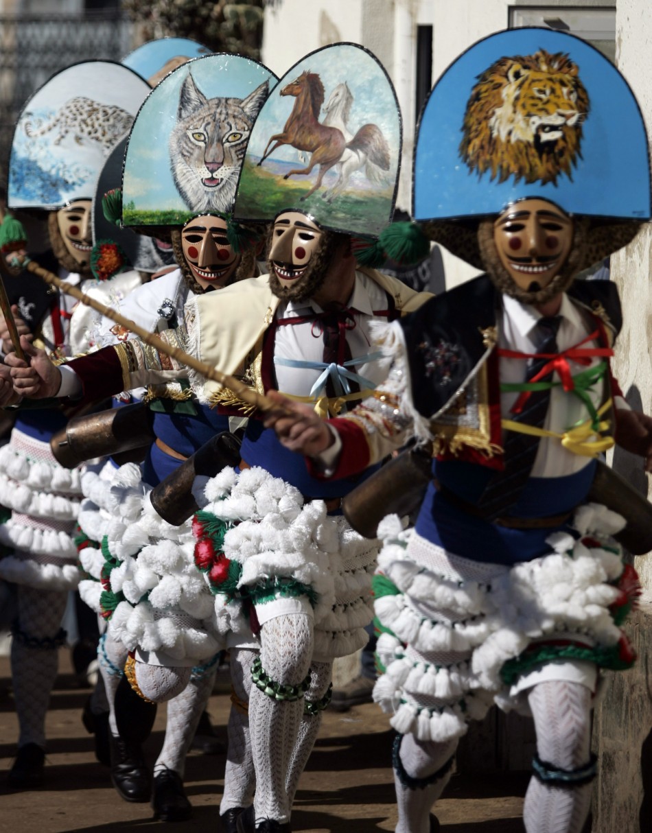 Revellers dressed as quotPeliqueirosquot run through a street during a carnival in Spains northwestern village of Laza