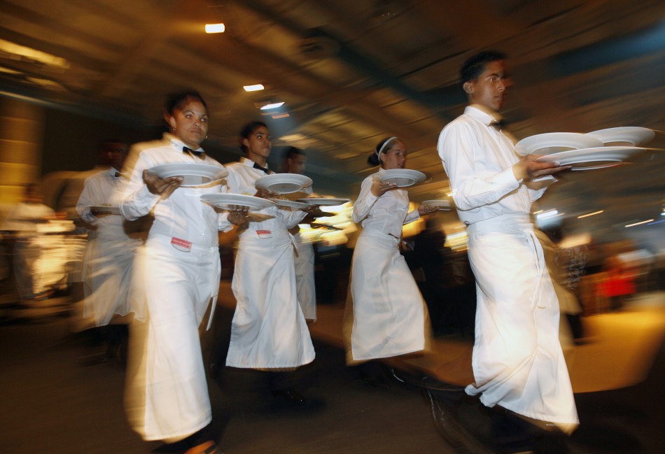 Waiters hold food during a gala dinner