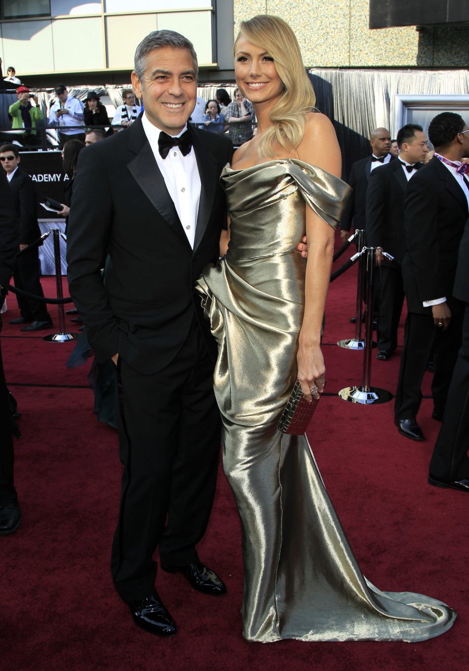 Actor George Clooney and girlfriend Stacy Keibler pose on the red carpet as they arrive at the 84th Academy Awards in Hollywood