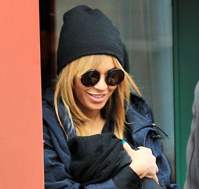 Beyoncé cradles baby Blue Ivy as she leaves restaurant in Manhattan