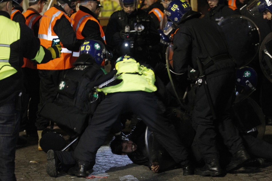 Riot police detain a protester during the eviction of the Occupy encampment outside St Paul039s Cathedral in London