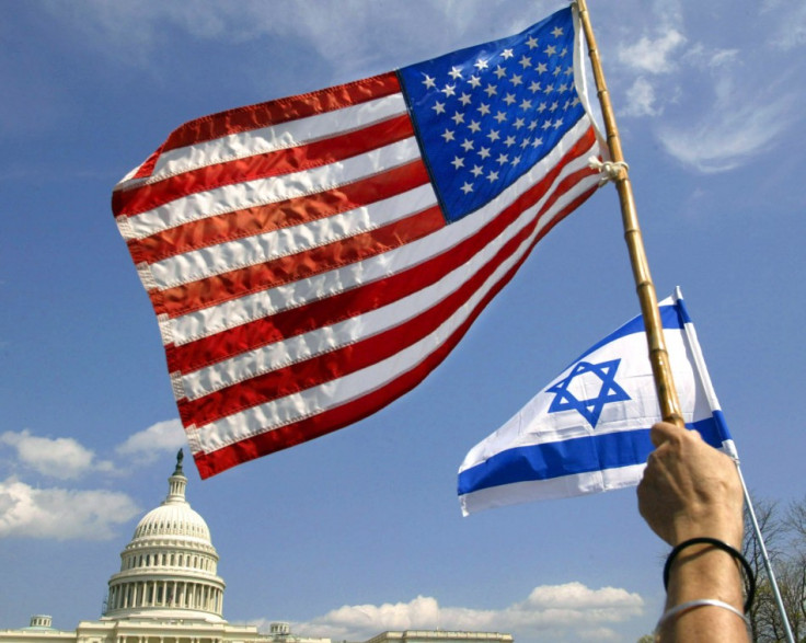 People wave U.S. and Israeli flags