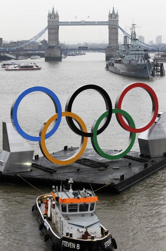 Backdropped by the historic Tower Bridge, a giant Olympic Rings floats on the River Thames in London in the run-up for the Olympic games, during its launch to mark 150-days until the start of the London 2012 Olympic games, Tuesday,