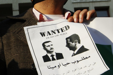 A Syrian man living in Lebanon carries a sign as he protests against Syrian President Bashar al-Assad during a sit-in demonstration in Beirut