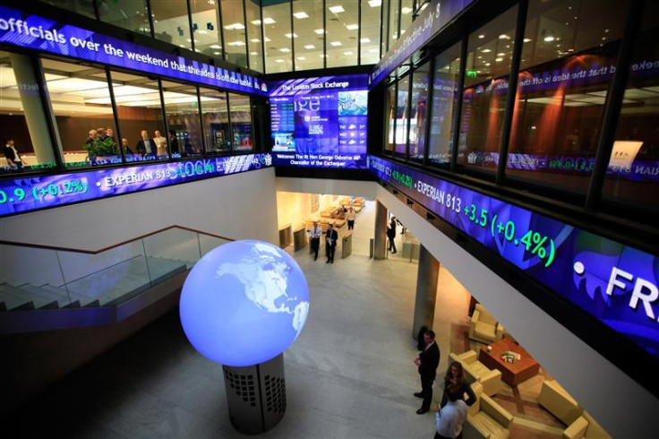 Financial data and news headlines stream accross ticker screens around the atrium of the London Stock Exchange