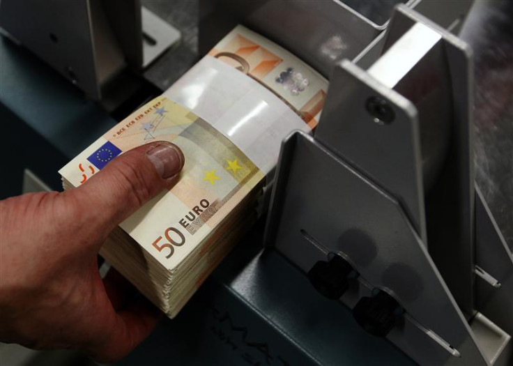 An employee at the Belgian Central Bank adjusts fifty-euro notes with a machine in Brussels An employee at the Belgian Central Bank adjusts fifty-euro notes with a machine in Brussels