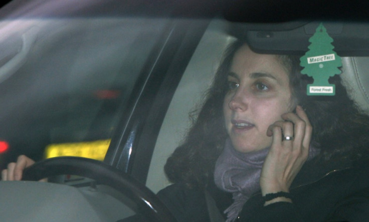 A woman uses her mobile phone whilst driving in London