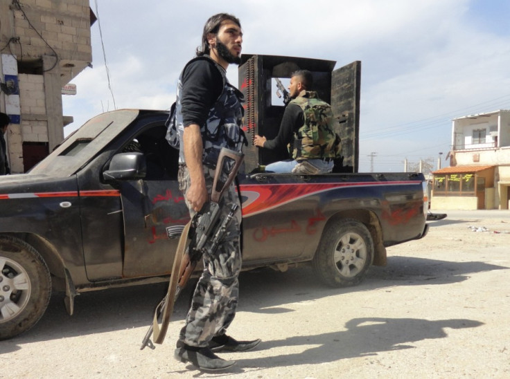 Members of the Free Syrian Army are seen deployed in al-Bayada district in Homs