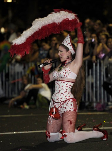 A woman sings a song as she moves along with the parade during the 2011 Gay and Lesbian Mardi Gras in Sydney, Australia Saturday, March 5, 2011