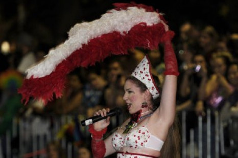 A woman sings a song as she moves along with the parade during the 2011 Gay and Lesbian Mardi Gras in Sydney, Australia Saturday, March 5, 2011