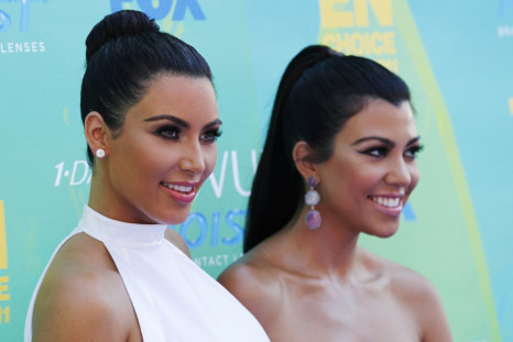 Kim Kardashian (L) and Kourtney Kardashian