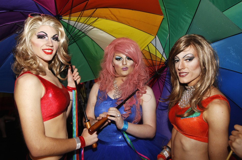 Revellers pose for pictures during the 34th annual gay and lesbian Mardi Gras parade in central Sydney