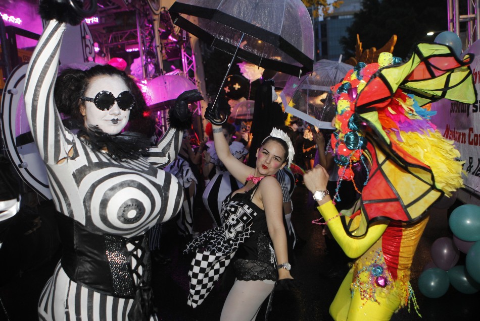 Revellers dance for pictures during the 34th annual gay and lesbian Mardi Gras parade in central Sydney