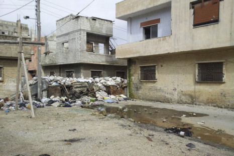 Damaged houses are seen in Karm Al Zaytoon, a neighbourhood of Homs