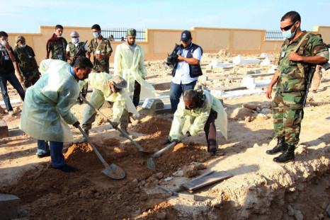 Bodies removed from mass grave uncovered in Libyan desert