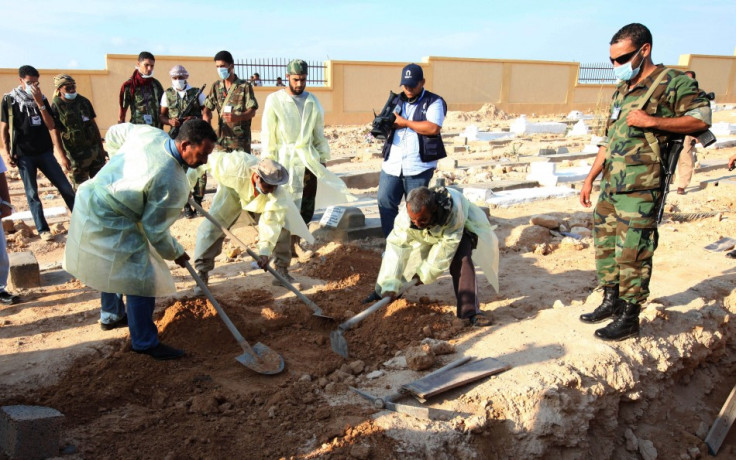 Bodies removed from mass grave uncovered in Libyan desert