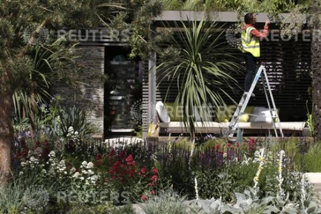 A worker prepares the Cancer Research UK Garden ahead of the opening of the Chelsea Flower Show 2011 on Tuesday in London