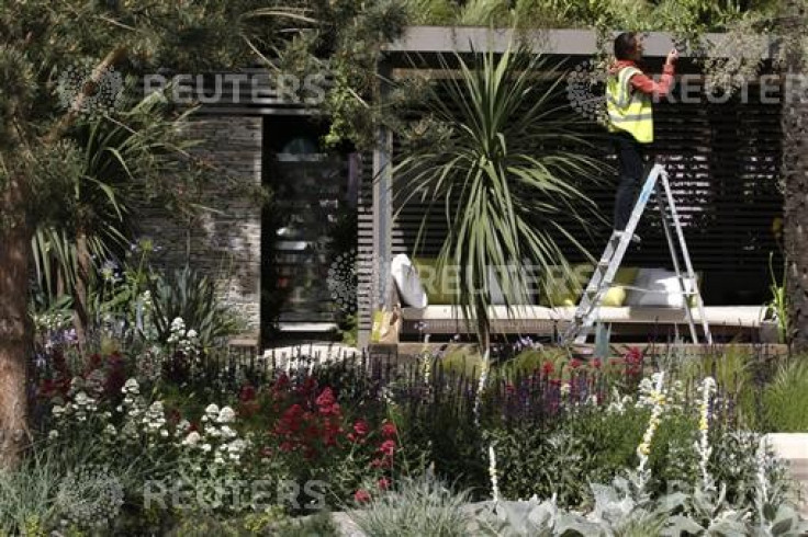 A worker prepares the Cancer Research UK Garden ahead of the opening of the Chelsea Flower Show 2011 on Tuesday in London