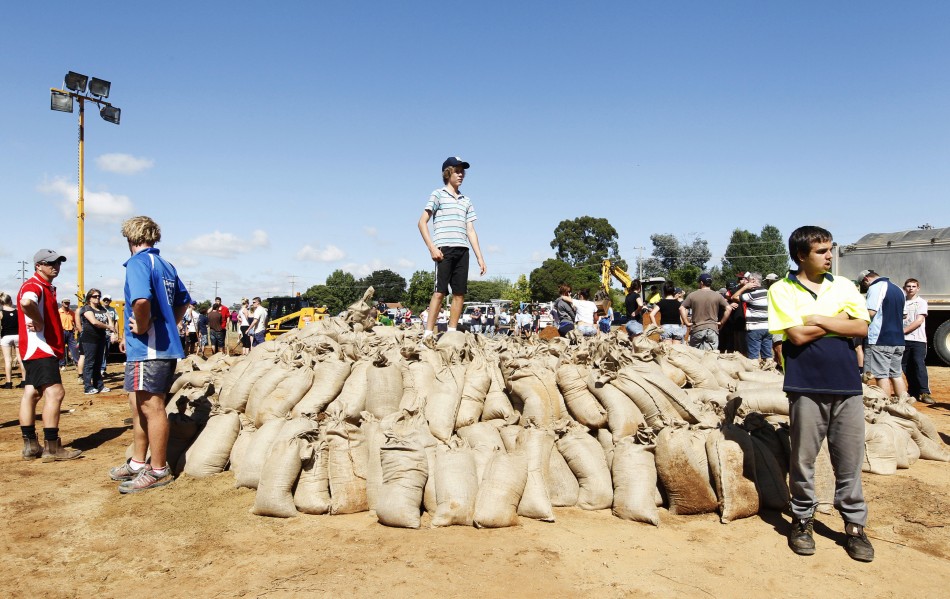 Locals wait for a truck to load sandbags in Wagga Wagga