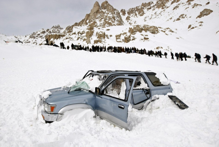 A vehicle is seen covered with snow after avalanches  in Parwan province February 10, 2010. (Reuters)