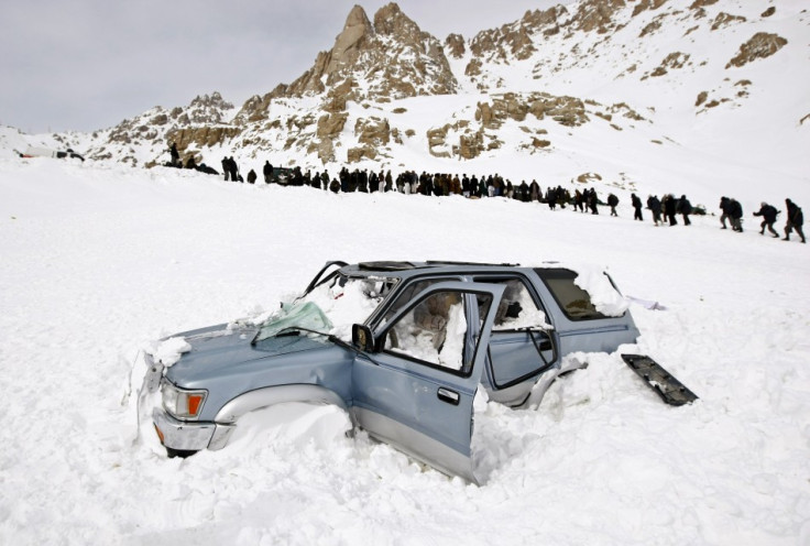 A vehicle is seen covered with snow after avalanches in Parwan province February 10, 2010. (Reuters)