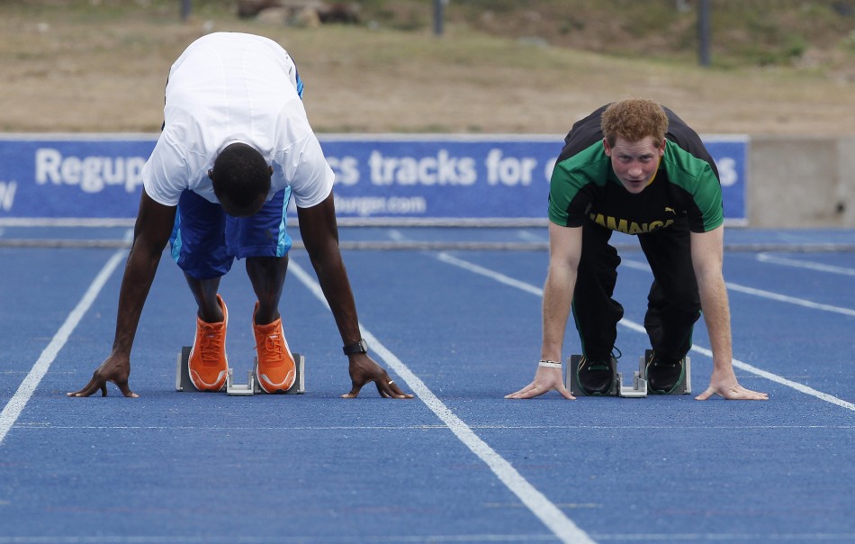 Britains Prince Harry R looks up as he and Olympic gold medallist Usain Bolt start a race