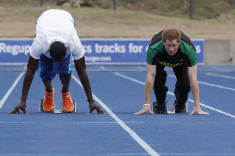 Britain's Prince Harry (R) looks up as he and Olympic gold medallist Usain Bolt start a race