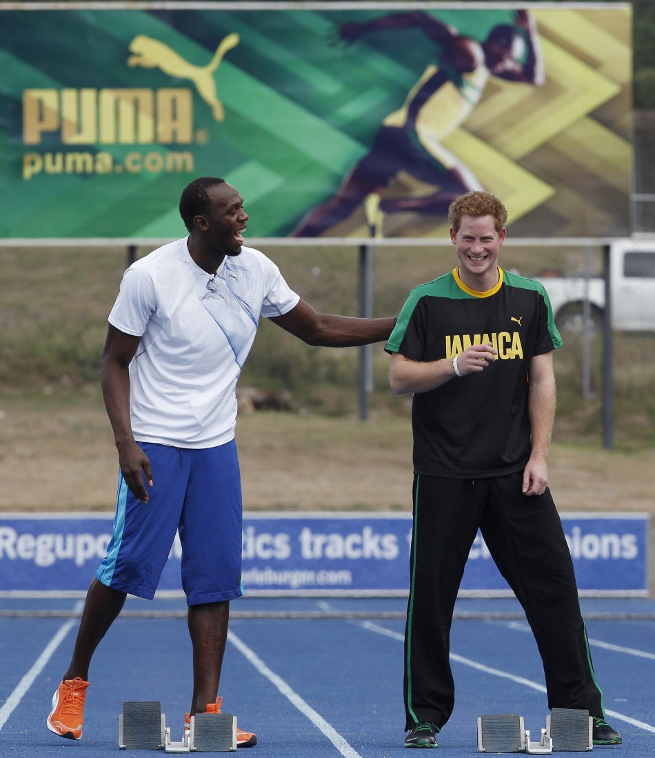 Britain039s Prince Harry R and Olympic gold medallist Usain Bolt talk at the starting blocks