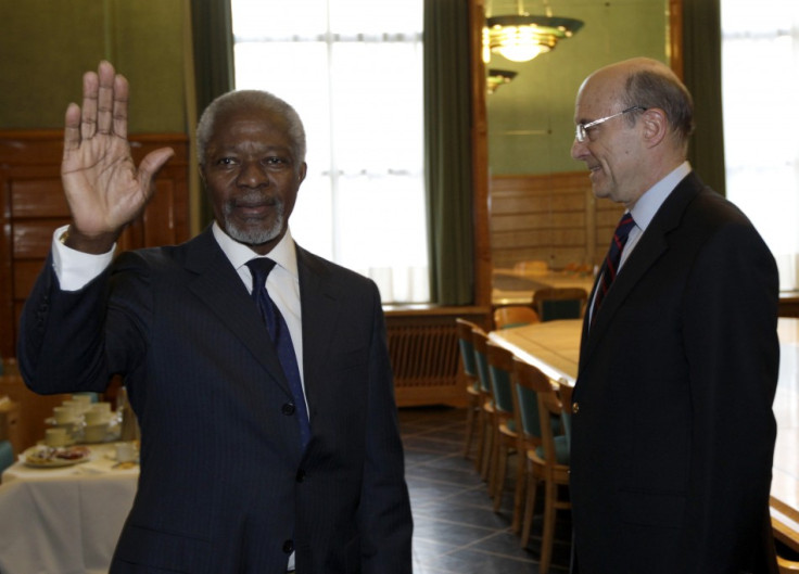 Newly appointed UN -Arab League Envoy on Syria Annan waves to the media after shaking hand with France's Foreign Ministe