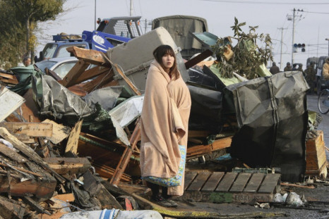 In Ishimaki City, a woman looks at the damage caused by a 2011 tsunami and earthquake