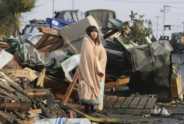 In Ishimaki City, a woman looks at the damage caused by a 2011 tsunami and earthquake