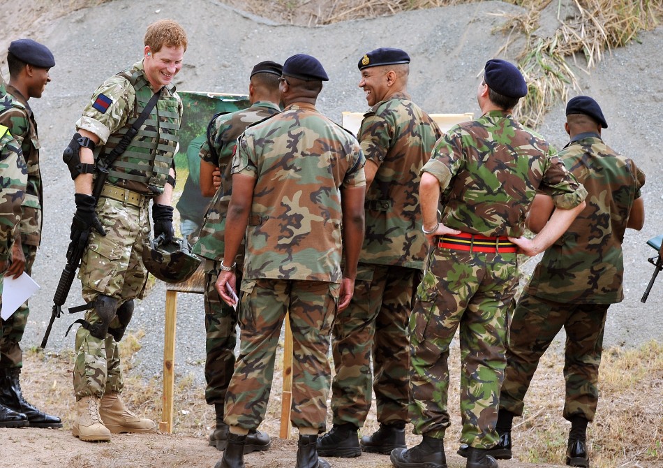 Britain039s Prince Harry 2nd L talks to members of the Jamaican Defence Force