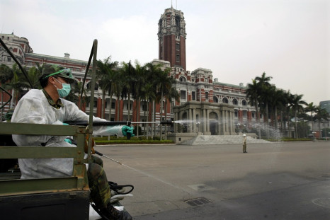 Taiwanese soldier sprays bleach outside presidential palace in Taipei during Sars outbreak