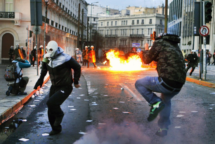 Protesters flee police after hurling petrol bombs at anti-austerity protests in Athens, unrest which has the potential to spread across Europe