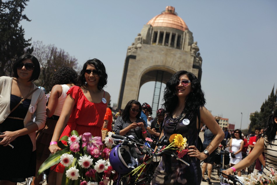 Women stand next to their bicycles before a ride to celebrate International Womens Day in downtown Mexico City