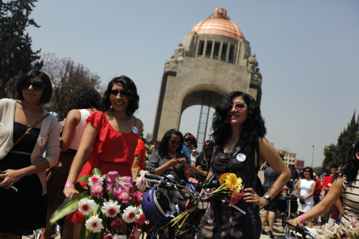 Women stand next to their bicycles before a ride to celebrate International Women's Day in downtown Mexico City