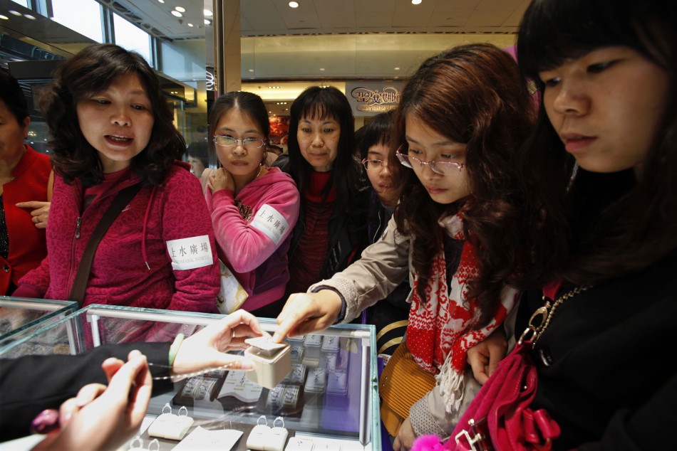 Chinese women look at jewelry during International Womens Day in Hong Kong