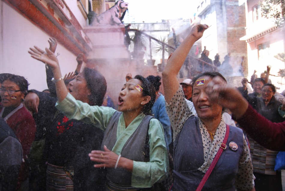 Tibetans take part in a ritual at a function to mark the Tibetan Uprising Day