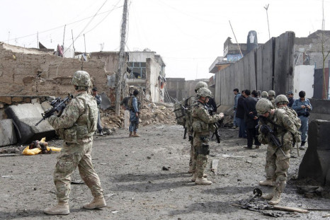 U.S. soldiers and Afghan policemen keep watch n Kandahar in February