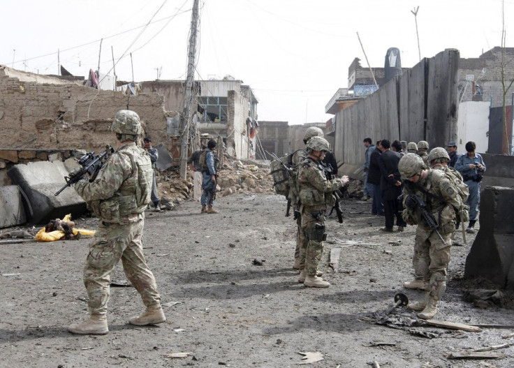 U.S. soldiers and Afghan policemen keep watch n Kandahar in February