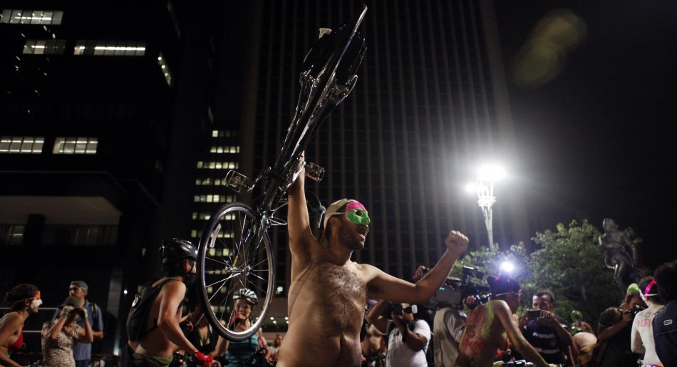Naked cyclist holds his bicycle up during the quotWorld Naked Bike Ridequot on Sao Paulo039s Paulista Avenue