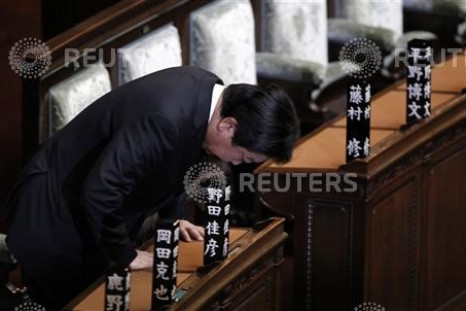 Japanese Prime Minister Yoshihiko Noda bows in the memory of his people