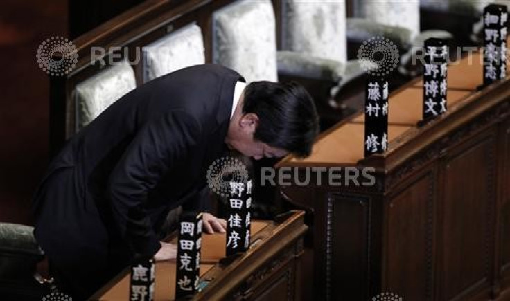 Japanese Prime Minister Yoshihiko Noda bows in the memory of his people