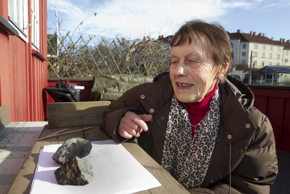 Anne Margrethe Thomassen looks at the meteorite, in central Oslo