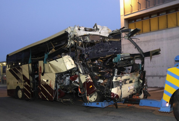 The wreckage of a bus that crashed into a motorway tunnel is pulled in Sierre, western Switzerland