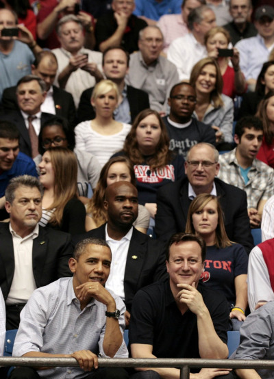 U.S. President Obama and British Prime Minister Cameron in crowd during NCAA basketball tournamnet U.S. President Obama and British Prime Minister Cameron in crowd during NCAA basketball tournamnet